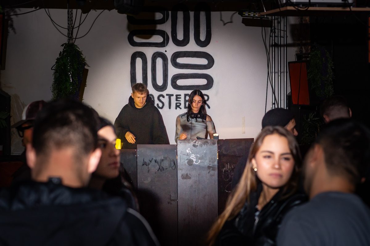 The floor, hands up, facing the booth
